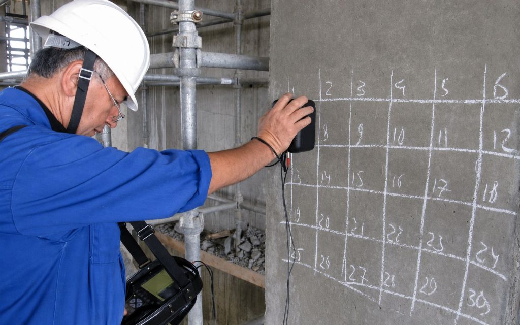 Ultrasonic flaw detector in use on a concrete structure